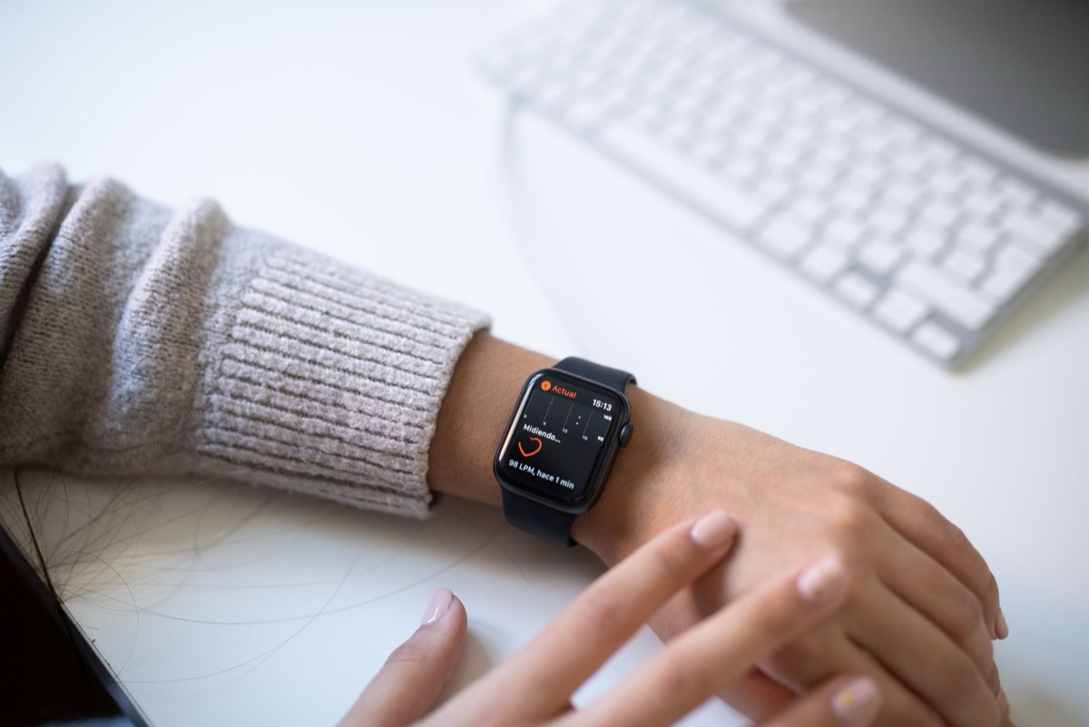 Professional athlete using smartwatch to monitor real-time health metrics and activity data