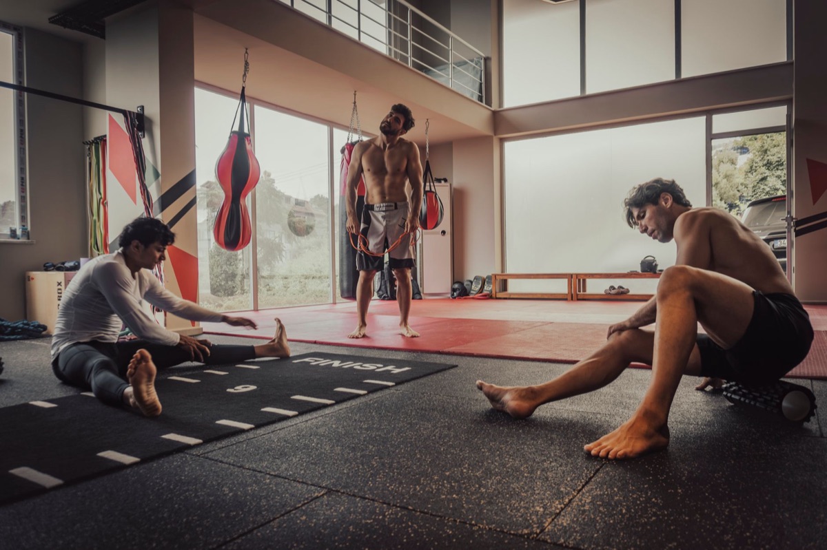 Gym stretching routine with people in motion