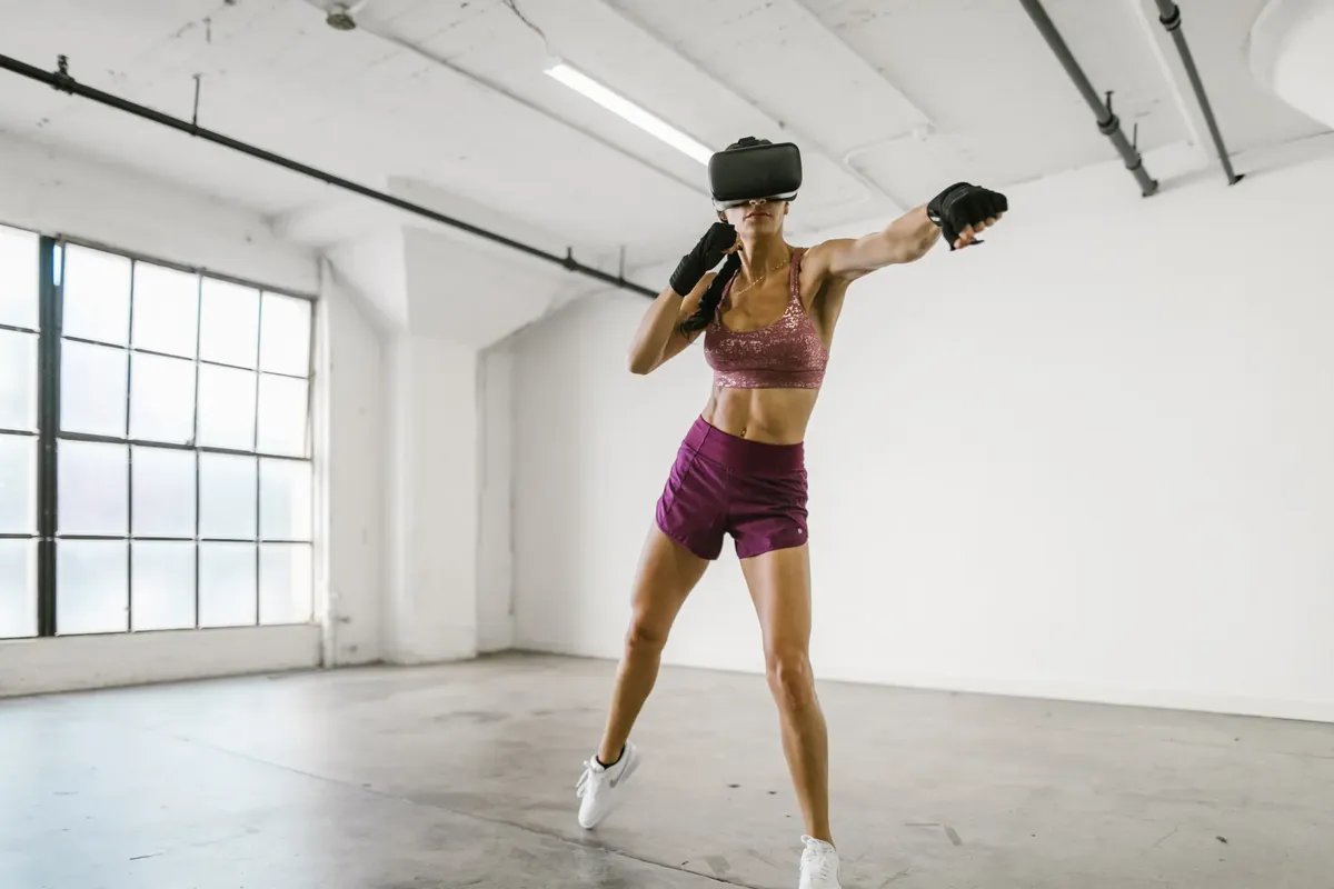 A woman engaging in a workout session using a VR headset indoors, promoting fitness and technology synergy.